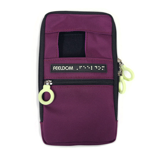 The front view of the Purple Wine Navi Pal, a rectangular pouch with a small window at the top for a phone camera. It has a zipper pocket on the lower half with a white ring pull. There's a FEELDOM Braille label going across the center.