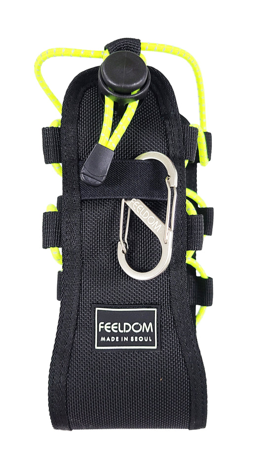 A black tactical water bottle holster with neon yellow reflective elastic cords on both sides that are able to be tightened or loosened using a large black cord stopper button on the front. The label says FEELDOM glow in the dark and heavy duty ballistic nylon including a metal carabiner.