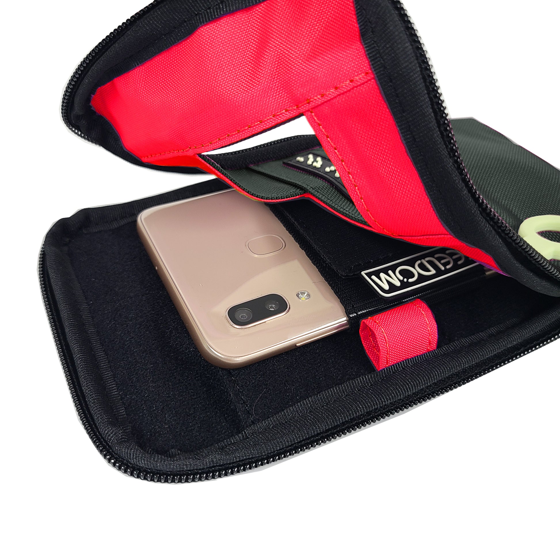 Open view of the Dark Gray Navi Pal pouch showing a flourescent red lining. The smartphone is secured into the holster, which is positioned along the center of the back of the pouch. There is a brightly colored pen loop along the inner edge.