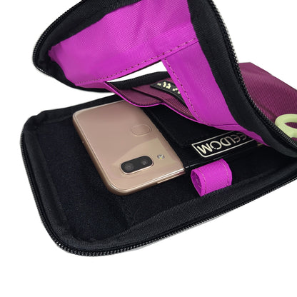 Open view of the Purple Wine Navi Pal pouch showing a bright purple (fuschia) lining. The smartphone is secured into the holster, which is positioned along the center of the back of the pouch. There is a brightly colored pen loop along the inner edge.