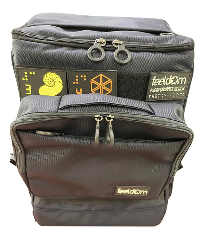 Front view of Feeldom's Performance Block Large bag with Tech Pouch attached to the front of the bag. It attaches to the webbing and is stabilized by a velcro strip along the back.